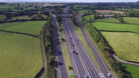 Looking Down onto Motorway Traffic Heading Home on a Early Autumn Evening Stock Footage 209148817