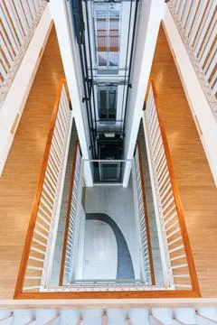 Looking Down Multi Story Building Atrium with Glass Elevator Shaft, Hallway.. 스톡 사진