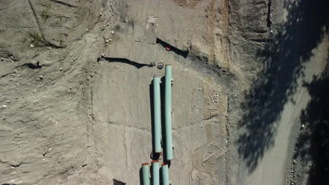 Looking down on multiple sections of pipe awaiting installation Stock Footage 163183703