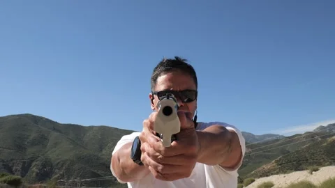 Looking down the muzzle barrel of a Desert Eagle pistol Stock Footage 252619235