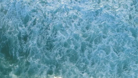 Looking down at ocean waves at sunset Stock Footage 103473029
