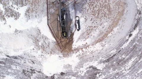 Looking down on an oil pumpjack in production from a drone. Stock Footage 233614040