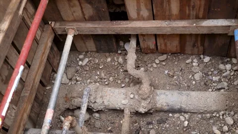 Looking down into open roadworks on a pipe on a construction site Stock Footage 263645380