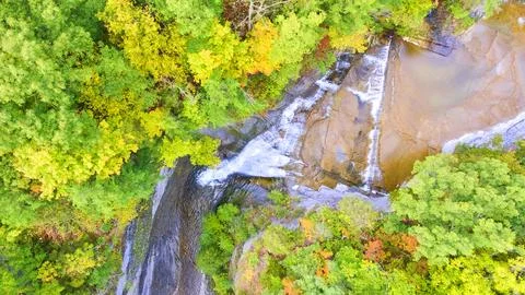 Looking down over waterfall going into deep gorge surrounded by green forest 스톡 사진