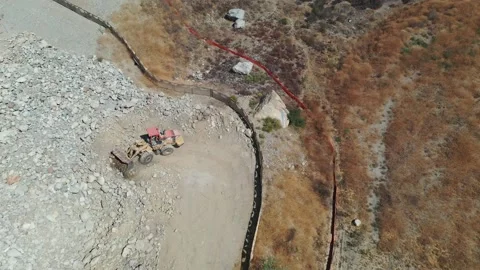 Looking down over wheel loader dumping rocks 動画素材 137419645