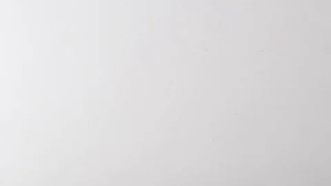 Looking down at paperclips dropped in slow motion Stock Footage 117349432