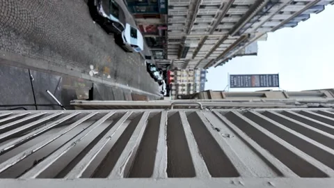 Looking down at a Parisian street with architecture and cars from a window Stock Footage 330910498