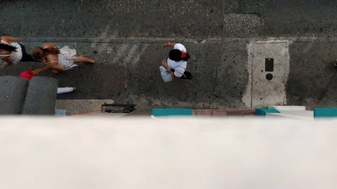 Looking down on people walking on the sidewalk Stock Footage 127932277