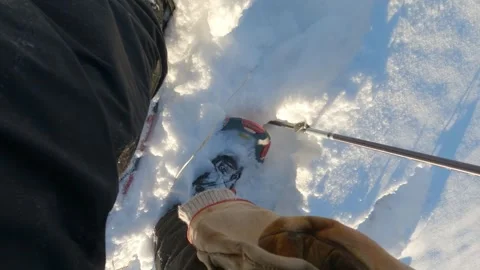 Looking down as a person prepared their snowshoes while surrounded by snow Stock Footage 299610695