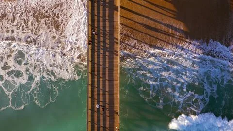 Looking down on a pier and beach Stock Photos