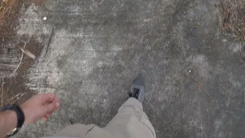Looking Down Point of View of Man Walking Through Brown Leaves Covering Ground Stock Footage 126576797