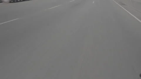 Looking down at the road as car is driving Stock Footage 252308341