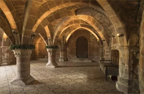 Looking down a room with a vaulted ceiling at a door Stock Photos