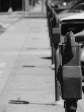 Looking down a row of pay parking meters on a sideway Foto stock