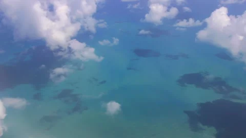 Looking down at the sea from the clouds on the plane Stock Footage 270508496