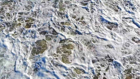 Looking Down At Sea Foam Very Close Ocean 4K Aerial Drone Shot Video stock 107287788