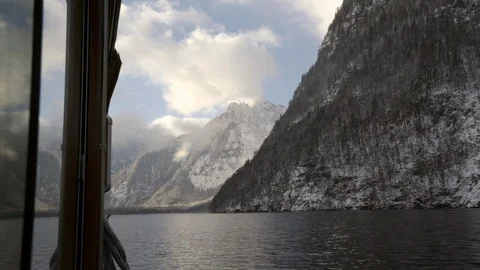 Looking down side of Boat into Bavarian mountains on Koenigssee lake in Winter Stock Footage 120989400