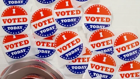 Looking down slider on I VOTED TODAY stickers on table Stock Footage 125203563