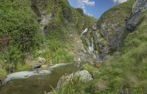 Looking down a small river at a waterfall Stock Photos
