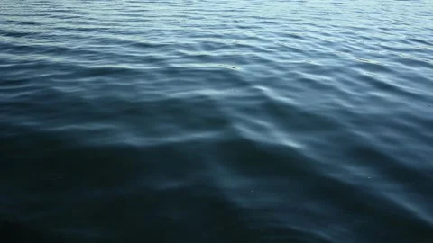 Looking down at small waves making interesting patterns on the water Stock Footage 276280727