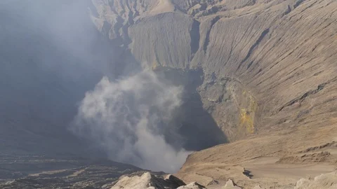 Looking down in smoking crater of volcano in Bromo Java Indonesia Stock Footage 82101966