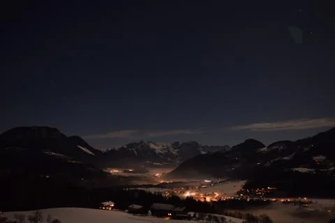 Looking Down into a Snow Covered Mountain Valley at Night Stock Photos