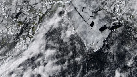 Looking down on Springtime cracked, melting ice, aerial view. Stock Footage 89174180