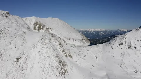 Looking Down a Steep Snowy Mountain Slope Stock Footage 332140126