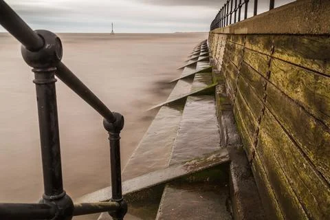 Looking down the steps at high tide Stock Photos
