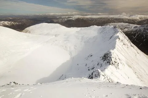 Looking down to Striding Edge on Helvellyn, Lake District, UK with a frozen,  Stock Photos