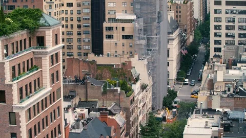 Looking down on summer roofs and traffic from midtown Manhattan Stock Footage 89673897
