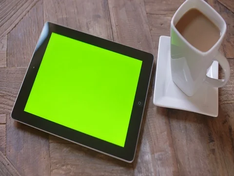 Looking Down on Tablet Move Right Coffee Mug on Table with Green Stock Footage 83064251