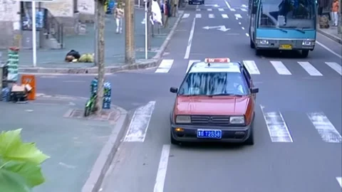 Looking down at a taxi pulling over Stock Footage 253772860