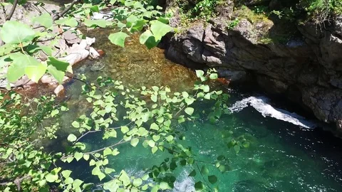 Looking down from the top of the hill on the waterfall trough the green trees in Stock-Footage 128305575