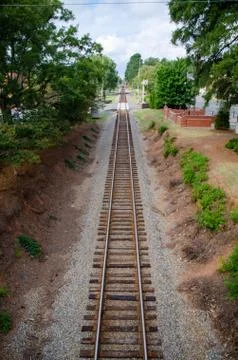 Looking down the tracks from a raised perspective. Stock Photos