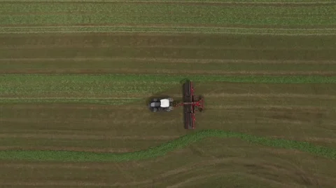Looking down on tractor collecting hay from drone Stock Footage 67871317