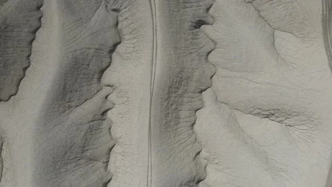 Looking down on trail running across a unique empty desert landscape Stock Footage 153872275
