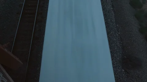 Looking Down at a Train Drive by Under Bridge Stock Footage 120130420