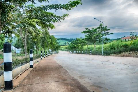 Looking down a tree lined road into the distance Stock Photos