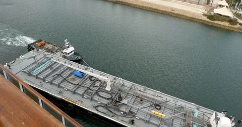 Looking down as tug boat guides refueling barge away from ship Video stock 106886745