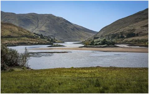 Looking down a valley at random islands in a lough Stock Photos