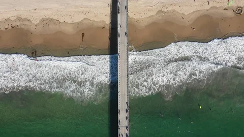 Looking Down on the Waves and Pier - Drone - 2K 動画素材 124983118