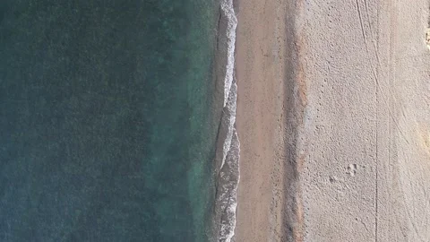 Looking down at the waves coming in to the beach. Stock Footage 232993179