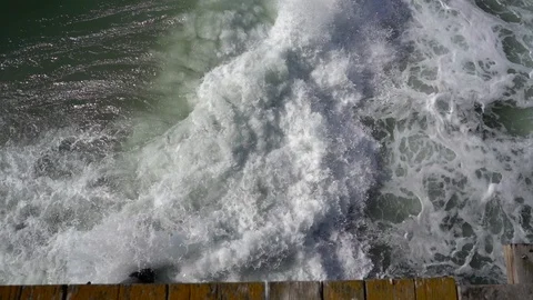 Looking Down at Waves Crashing Underneath Pier in the Pacific Stock Footage 96038424