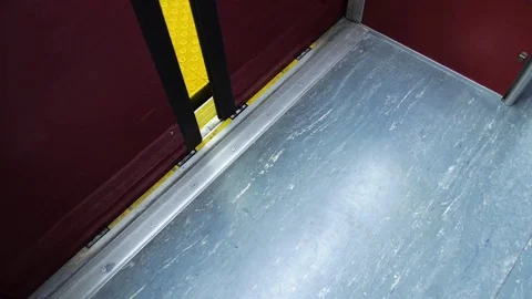 Looking down at the yellow warning strip as subway doors close Stock Footage 82374452