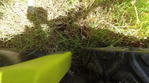 Looking downward on a lawn mower while it mows grass Stock-Footage 312767476