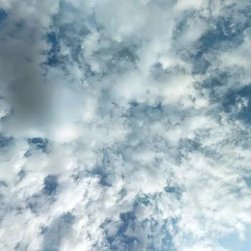 Looking Up at Dramatic Cumulus Clouds Against Blue Sky Fotos de archivo