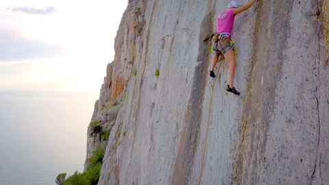 Looking with a drone a climber over the sea Stock Footage 80613767