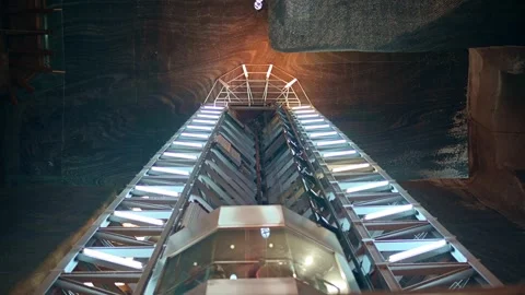 Looking up at elevator ascending in vast industrial salt mine shaft with br.. Stock Footage 339212701