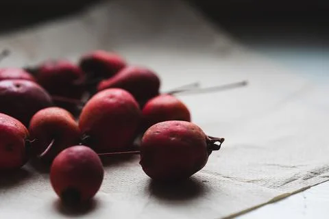 Looking at evening windowsill. Selective focus on red paradise apples in th.. Stock Photos